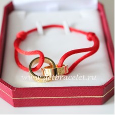 Гривна Cartier с двоен пръстен Love от жълто злато и червено въже